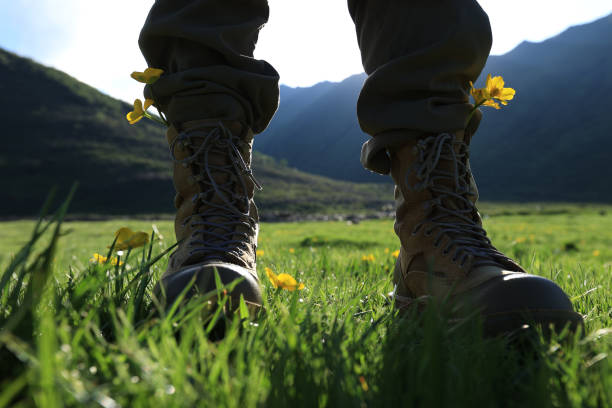 Woman hiker walking on trail in grassland