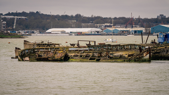 Hoo Marina Park, Kent, England, UK - March 21, 2023: Shipwrecks on the banks of the River Medway