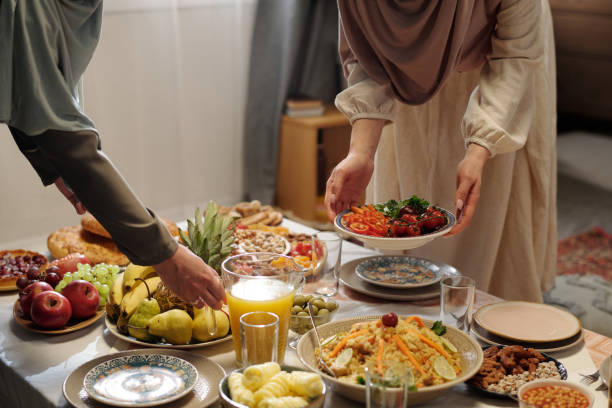 istock Unrecognizable Muslim Women Setting Festive Table 2129258266