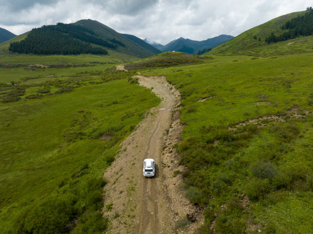 istock Car road trip on the high altitude mountain trail, China 2129268428