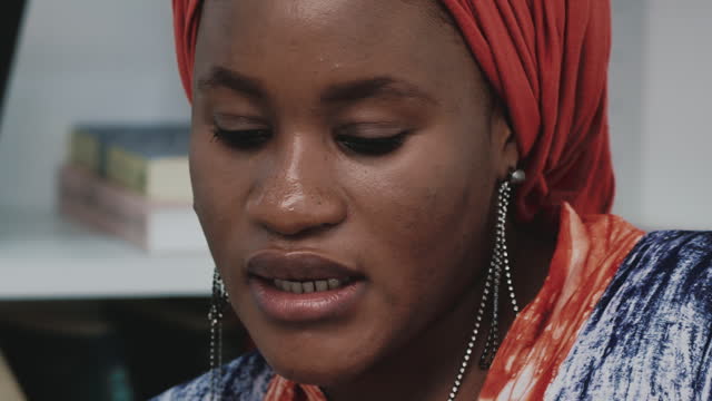 Close up of African muslim woman reading a book