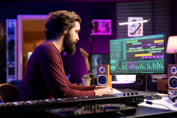istock Musical composer writing a song with new lyrics in home studio 2129284057
