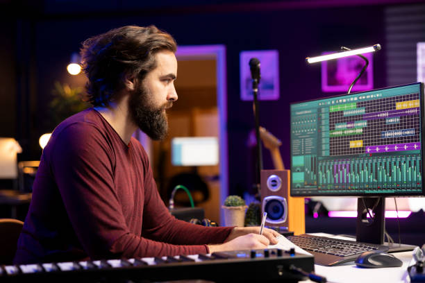 istock Songwriter taking notes to create new music in his home studio 2129284145