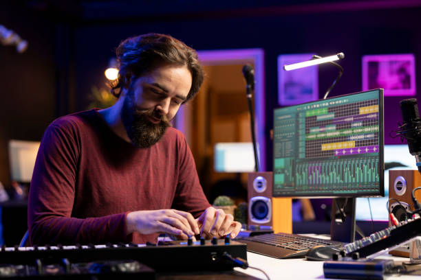 istock Young artist recording piano synthesizer notes and editing on a mixing console 2129288298