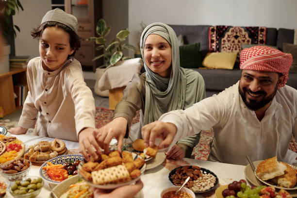 istock Muslim People Taking Cookies During Family Dinner 2129290379