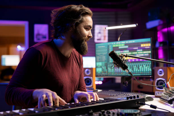 istock Musician singing and playing electronic keyboard uses recording gear 2129290893