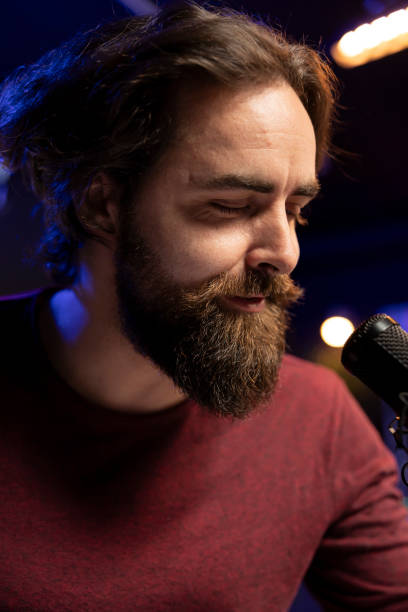istock Songwriter composing new music and singing on microphone 2129291965