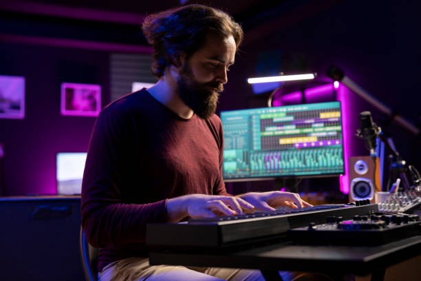 istock Skilled artist creating new music on electronic midi controller in home studio 2129294686