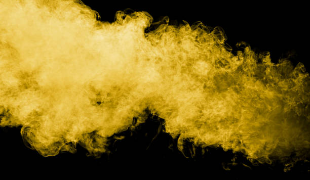 istock Yellow smoke isolated black background 2129308351