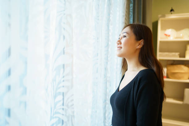 istock Woman relaxing in living room. 2129309946