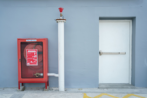 The fire hydrant valve and emergency fire protection exit door in the building.