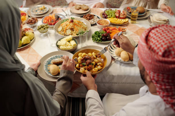 istock Unrecognizable Muslim Family Sharing Food During Dinner 2129312542
