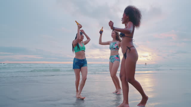 Group of friends having fun on the beach and drinking fruit juice. Summer beach.