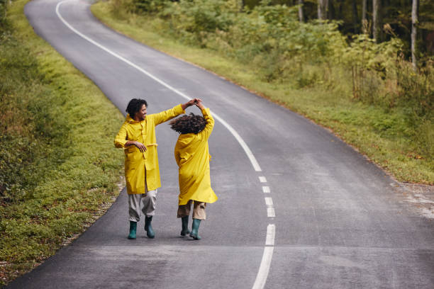 istock Carefree black couple dancing on empty road. 2129323022