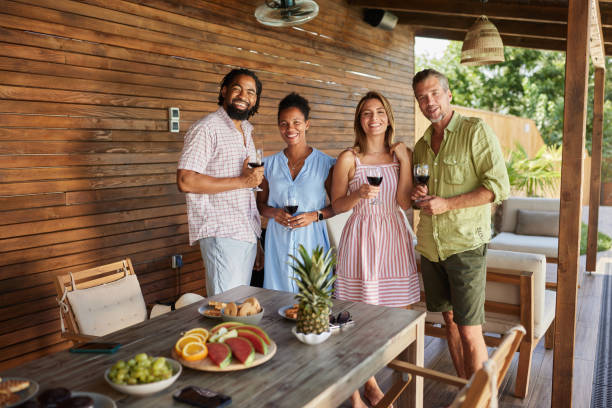 istock Group of happy diverse friends drinking wine on a patio. 2129330441