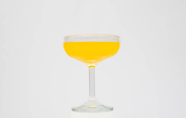 istock Orange juice in wine glass on white background 2129330916