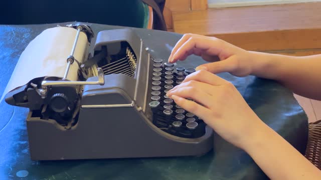 Pressing the keys of an old typewriter machine
