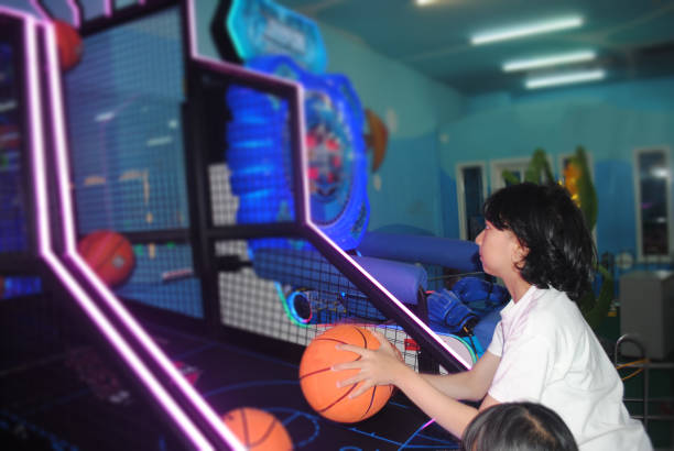 istock Girl is playing basketball in amusement arcade. 2129333553