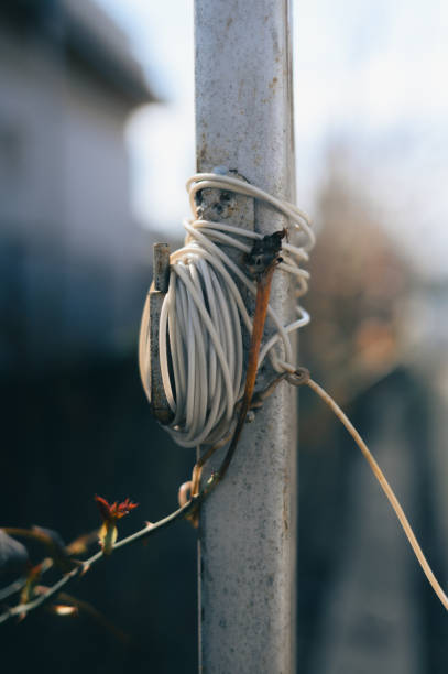 A cable coiled around a city street pole, leading the eye to the horizon