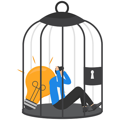 Blocking business ideas, stucking in a bad workplace, rivalry for better position in organization, toxic environmental office concepts. Dismal businessman stucking in a cage with a bright light bulb.