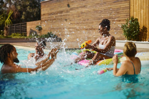 istock Playful diverse friends having fun during summer day in the pool. 2129336787