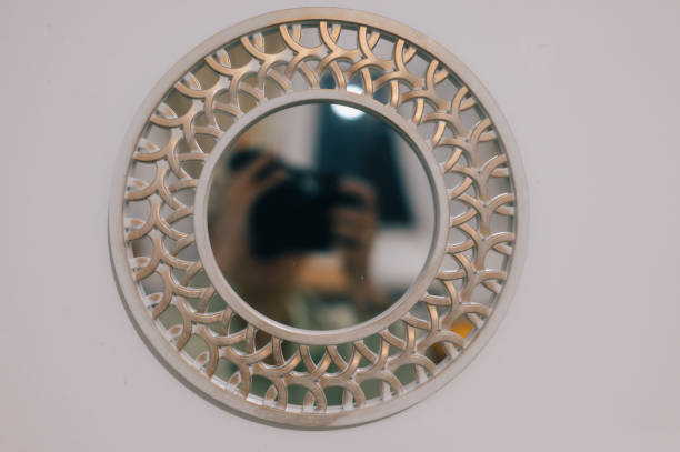 istock a mirror mounted to the wall above a mirror has intricately decorated design 2129336795