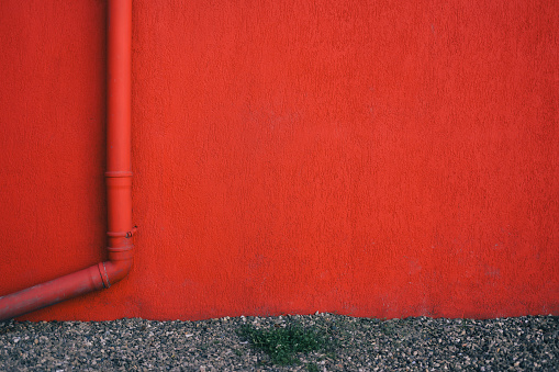 A white fire hydrant against a wall