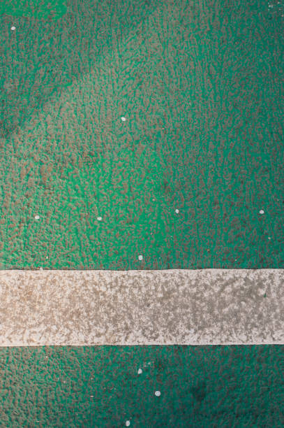 An image featuring a parking lot with vibrant green lines marking the spaces