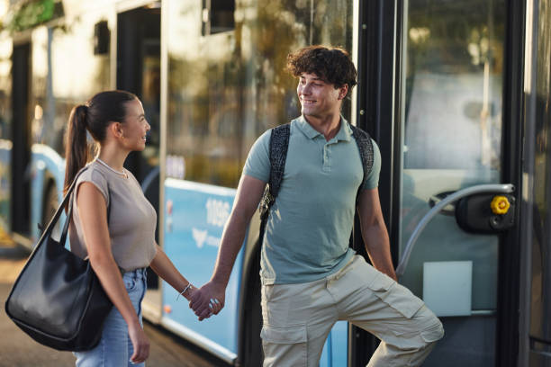 istock Happy couple talking while entering the bus. 2129353067