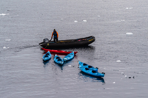 Prospect point, Antarctic Peninsula - January 30, 2024. Crew members of the Antarctic exploration vessel Ocean Adventures prepare zodiacs near prospect point to explore the area.