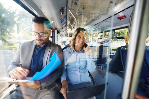 istock Happy business people working in a public transportation. 2129358270