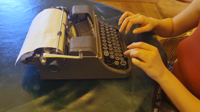 Writer typing with retro writing machine