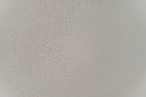the white wall is mostly untidy and has holes to cut into it
