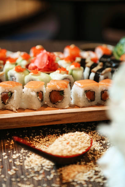 istock Wooden Platter Filled With Sushi and Vegetables 2129381754