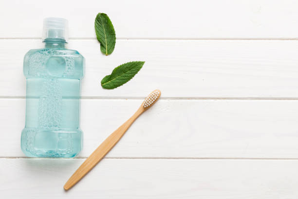 istock Mouthwash and fresh mint on colored background, top view with copy space for text 2129381755