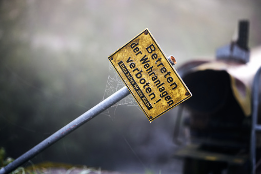 Close-up of a sign on a pole next to a car