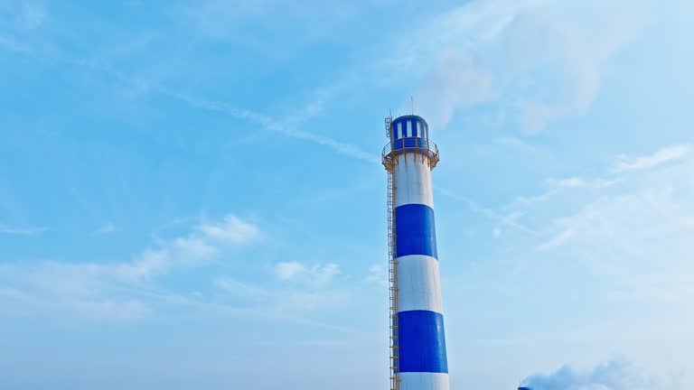 Aerial pan shot of industrial chimney building