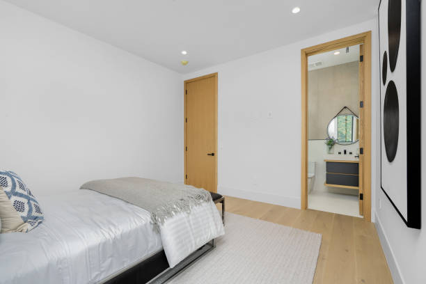 istock Spacious bed in a bedroom next to a door. 2129436182