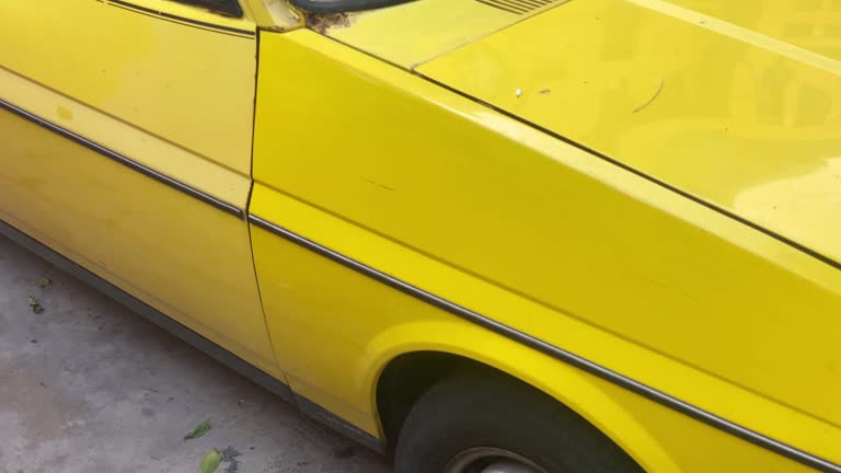 Yellow vintage car parked in the street