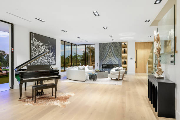 istock Room with a grand piano, sofas, and expansive windows. 2129436698