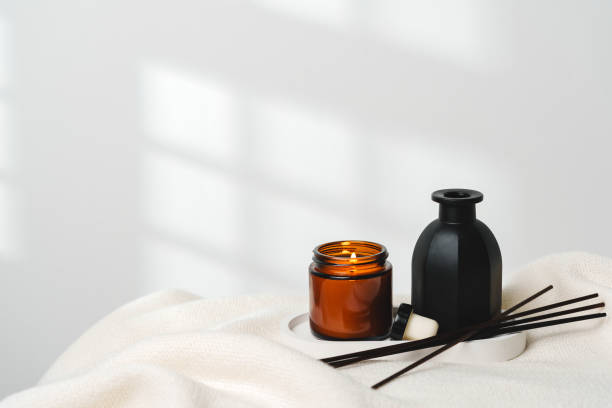 istock Elegant Aroma Diffuser With Reed Sticks And Scented Candle On White Tablecloth 2129443167