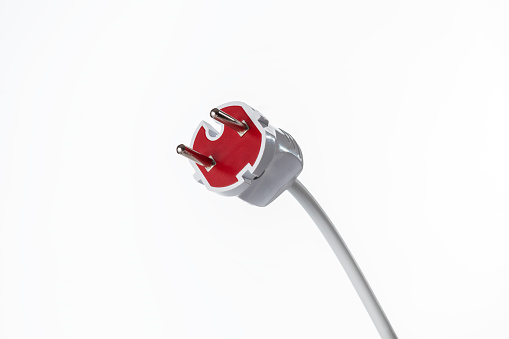 Mains plug with cord close-up on white background as a concept of electrical appliances for household use in the home