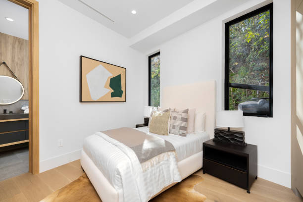 istock Bedroom featuring a white bed and wooden floors. 2129446015