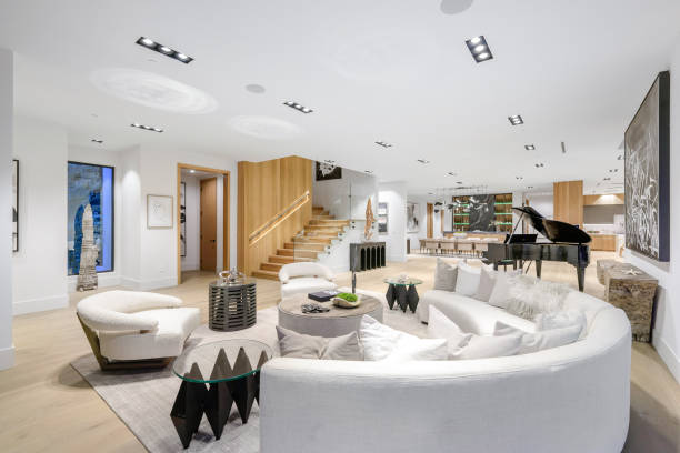 istock White sofa, two black chairs, and a piano in the room. 2129446530