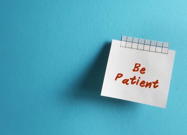 istock Stick note on copy space background with text written Be Patient - positive message to remind oneself to have patience - keep calm and deal with frustrating situations calmly 2129458033
