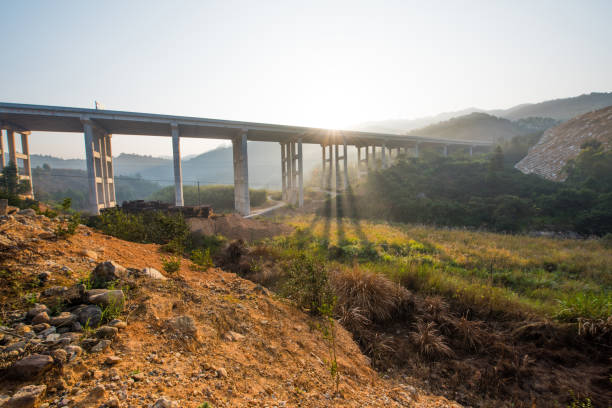 The elevated bridge at sunrise in the morning and the highway between the two mountains.