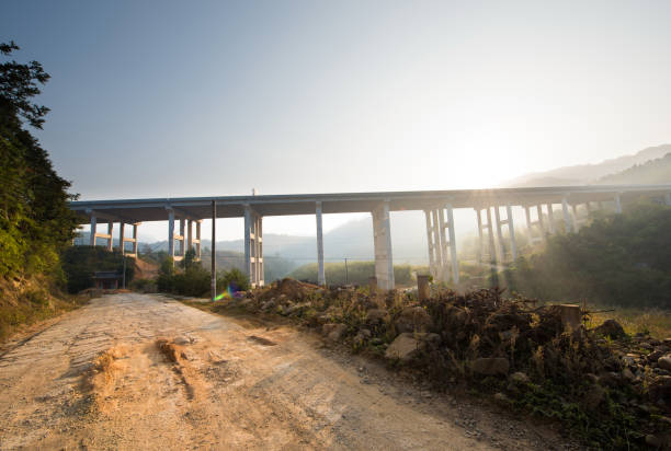 The elevated bridge at sunrise in the morning and the highway between the two mountains.