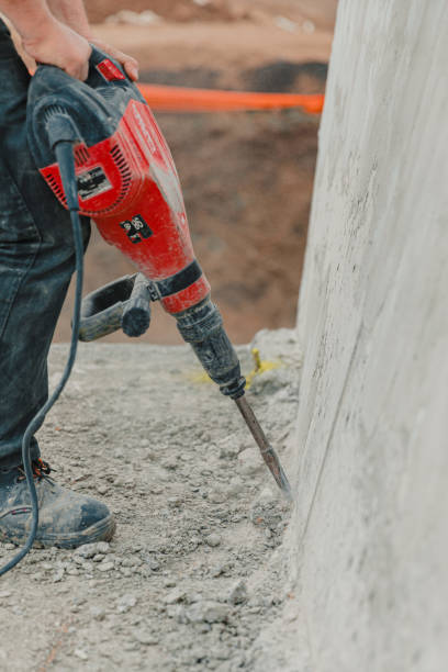 istock Worker Operates Rock-Drill, Excavating Ground at Construction Site 2129475356