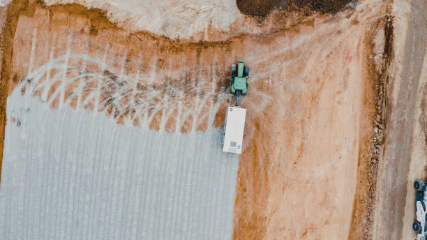 istock Aerial View of Heavy Equipment Machine On Field, Soil Compactor. 2129476831