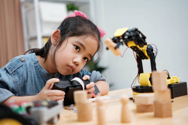 istock A young girl is playing with a remote control a robot 2129479972